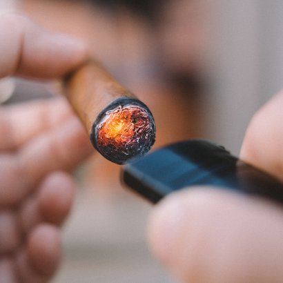 toasting the foot of a cigar